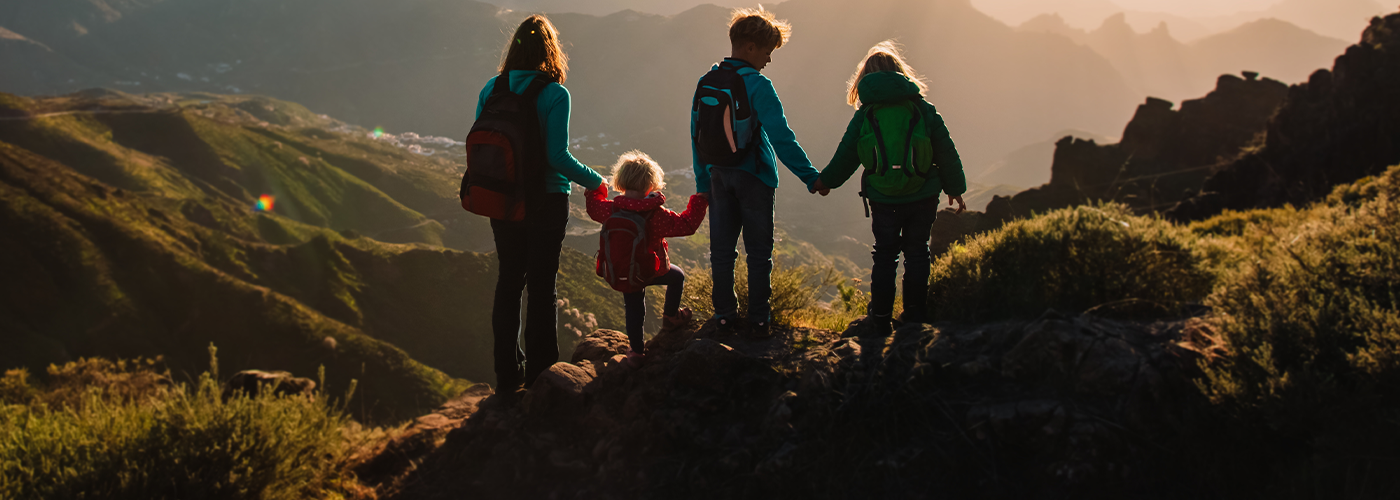 Group of 4 children pausing on a hike to look at the rolling hill view. Nourish your families adventures with gnusante health beverages